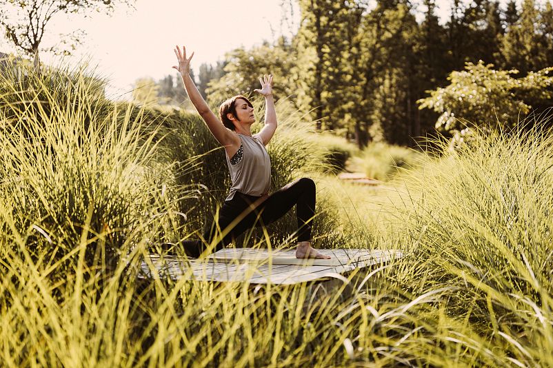 Outdoor yoga on the wooden deck at the Seezeitlodge