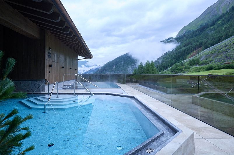 Heated outdoor pool at Alpenhof Hintertux in misty atmosphere
