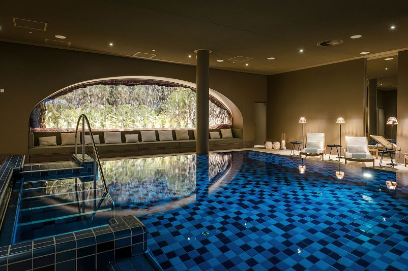 Indoor pool with water wall at the Seezeit Spa